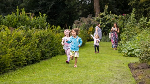 Family visitors in Summer in the garden at Nostell Priory, West Yorkshire